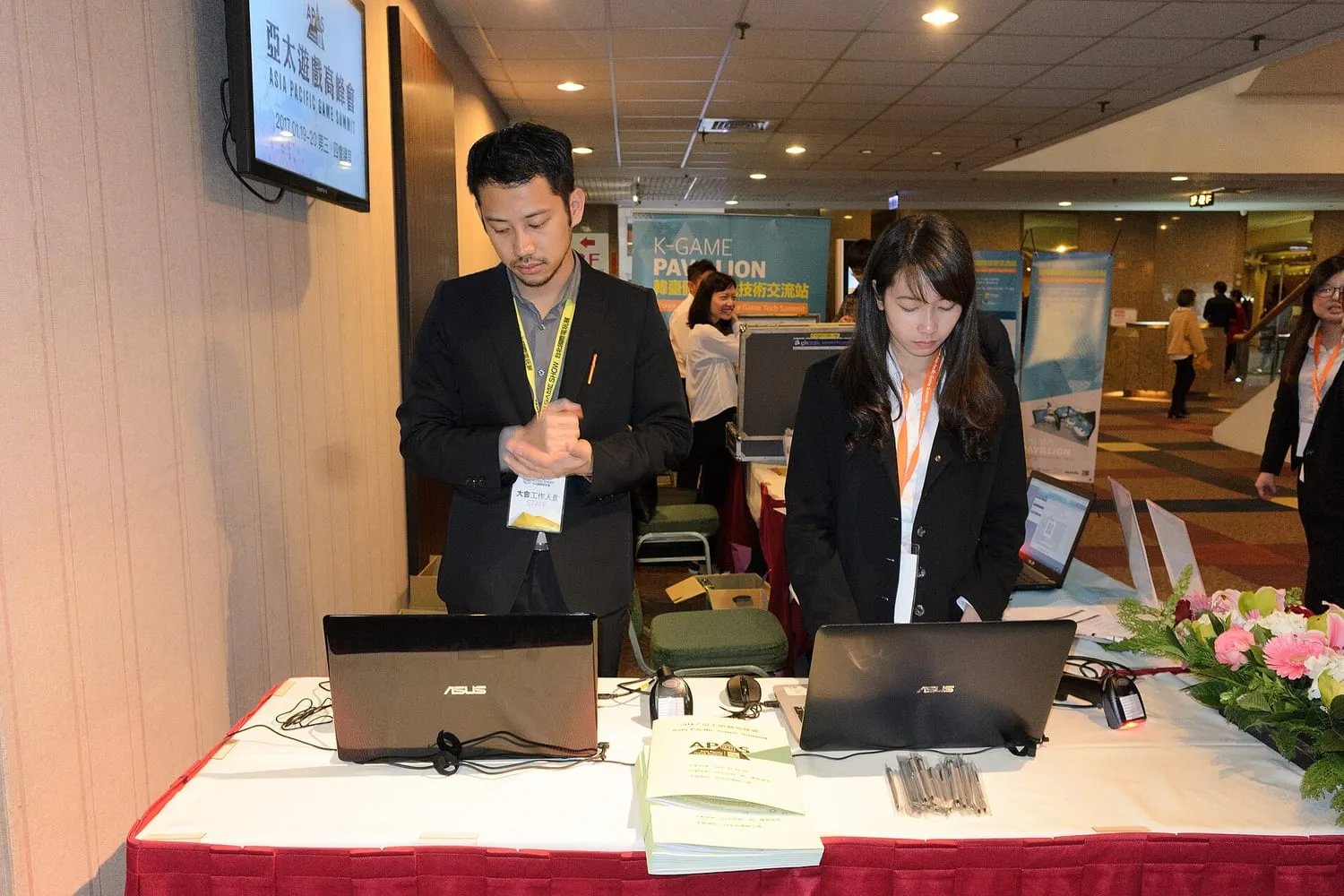 Staff at a service desk where used devices are checked in