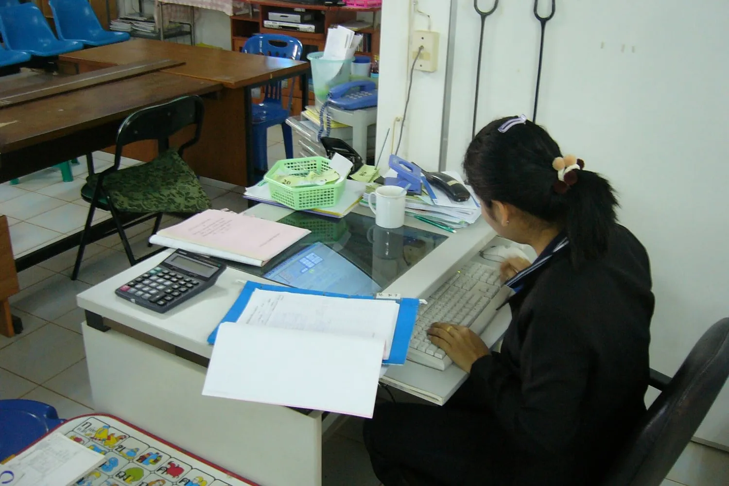 A tablet with a keyboard and a stylus on a desk